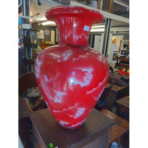 552 - Oversized red Oriental style vase. Appears to be painted plaster. 65cm high.