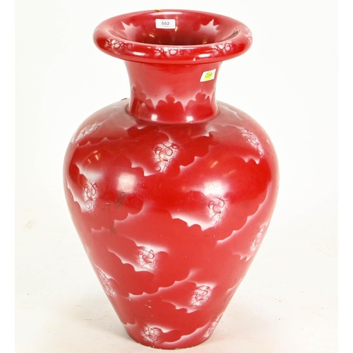 552 - Oversized red Oriental style vase. Appears to be painted plaster. 65cm high.