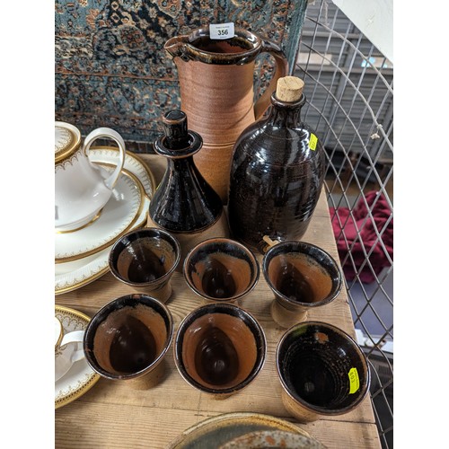 356 - Muchelney stoneware jug together with a tapped flagon, 6 goblets, planter and tray.