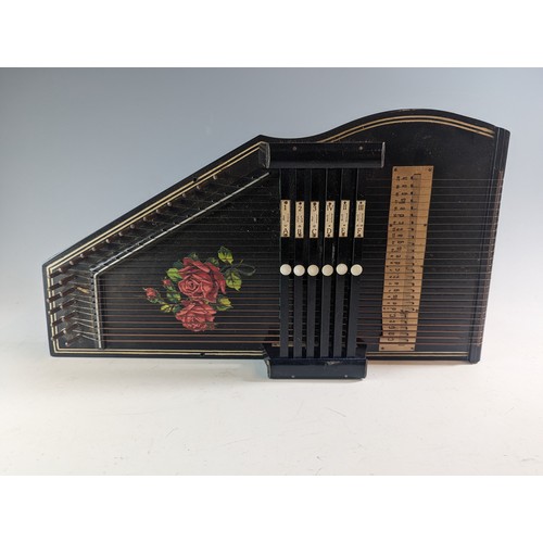 148 - Autoharp with rose design and original booklet.46cm by 25cm by 8cm