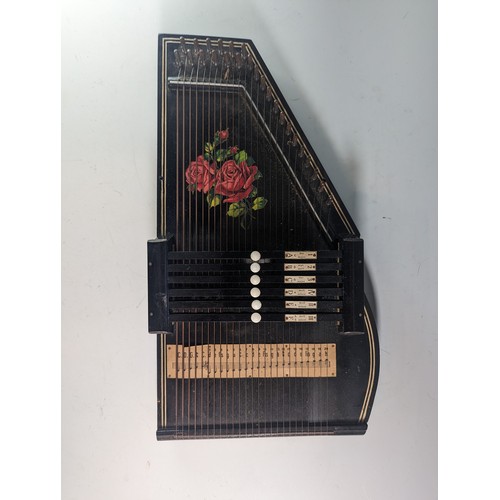 148 - Autoharp with rose design and original booklet.46cm by 25cm by 8cm