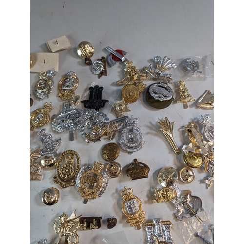 292 - Collection of military badges and buttons