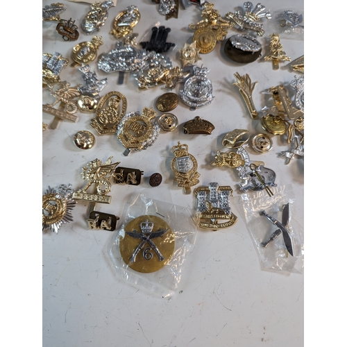 292 - Collection of military badges and buttons