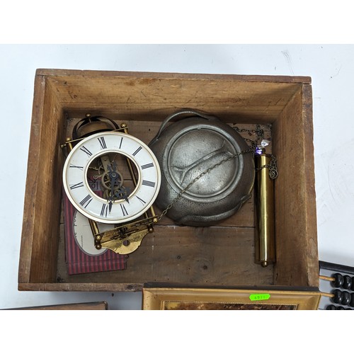 498A - Wooden box of collectable items inc Lotus flower Abacus, brass skeleton clock, wooden fishing reel, ... 