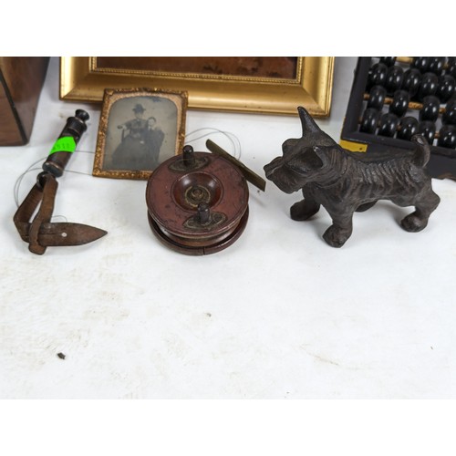 498A - Wooden box of collectable items inc Lotus flower Abacus, brass skeleton clock, wooden fishing reel, ... 