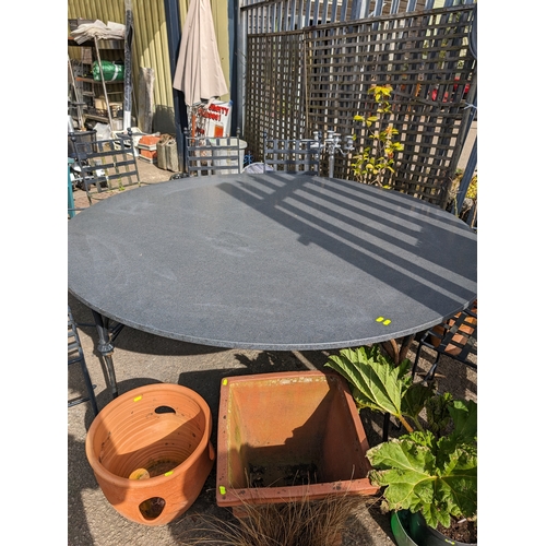 168 - Impressive granite topped circular garden table with metal base. D176cm H80cm