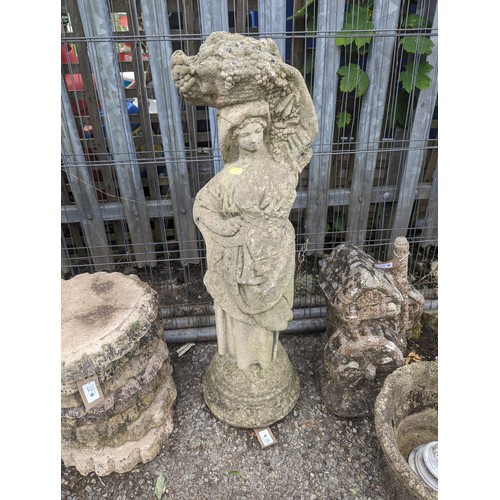 26 - Concrete statue of a lady with harvest, ht. 79cm approx.