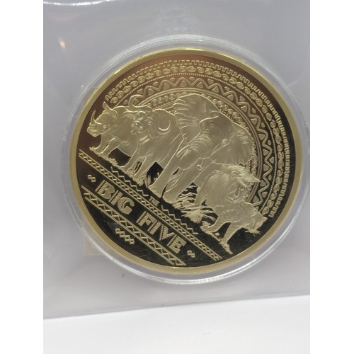 757 - Two large plated commemorative medallions, resin coated US 1974 half dollar, H.M. Queen Elizabeth II... 