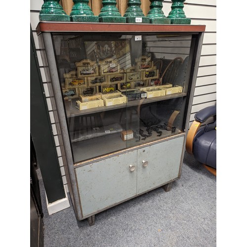 721 - Industrial vintage metal and glass fronted display cabinet with lower cupboard. 