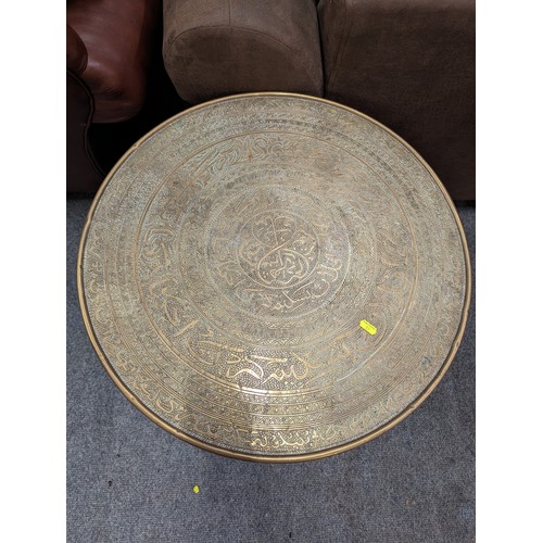 709 - Two ornately decorated Benares tables. Diameter 60cm.