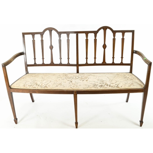 41 - Edwardian mahogany settee, raised on arrow supports. W138cm