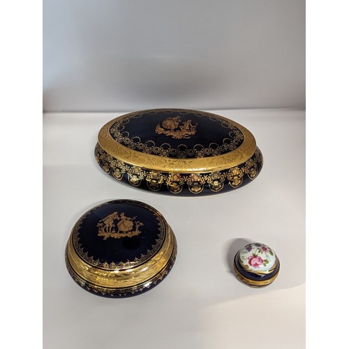 162 - Limoges, two La Reine lidded pots together with a cobalt blue and gilt spherical pot containing glas... 