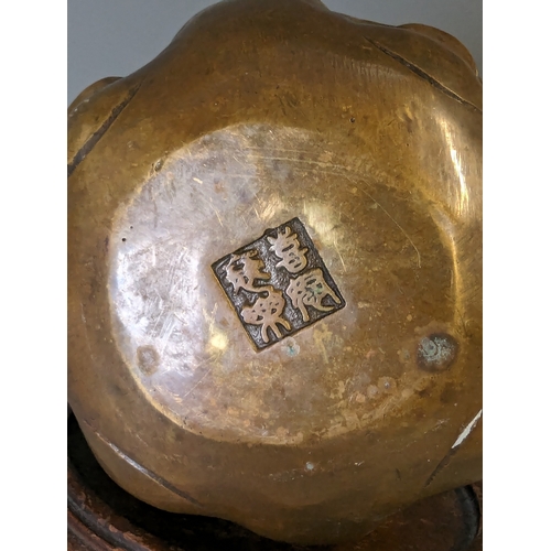 467 - Four sided Buddha head, character marks to the base brass, on a wooden stand. total height 22cm appr... 