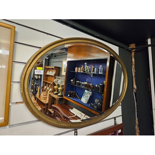 24B - Oval bevelled gilt framed mirror 97 x 60cm