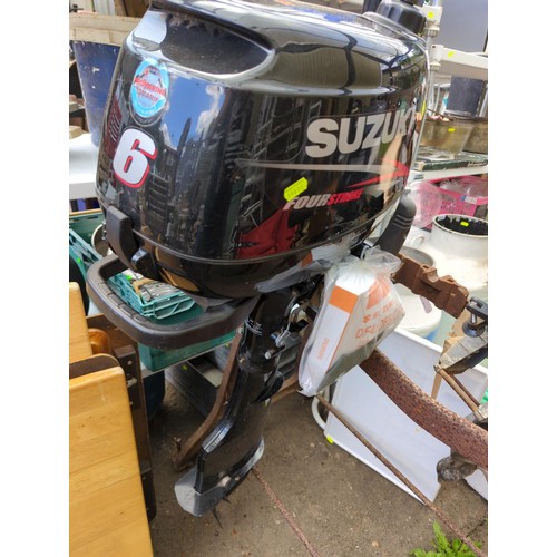 127 - Suzuki 6, 4 stroke outboard motor with owners manual and tools