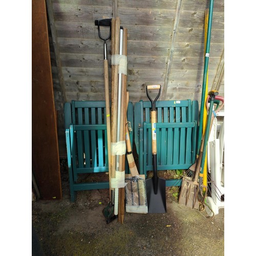 69 - Small collection of long handled tools together with a collection of tool handles