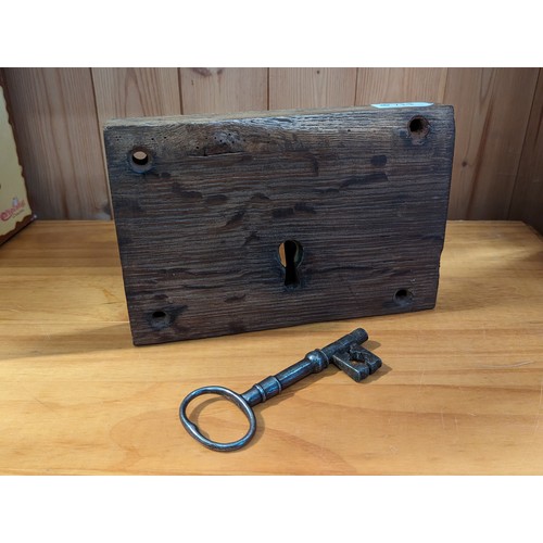 714 - Large vintage metal lock in wooden surround with key