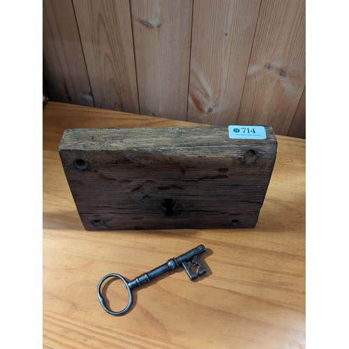 714 - Large vintage metal lock in wooden surround with key