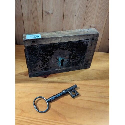 714 - Large vintage metal lock in wooden surround with key