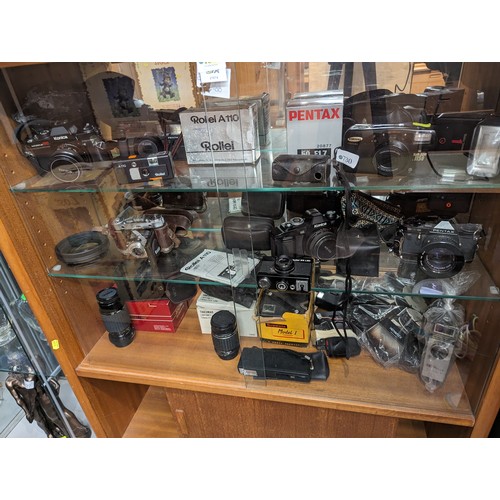 730 - Three shelves of cameras and accessories inc. Rollei 35 LED, Rollei A110, Konica, Pentax, Samsung et... 