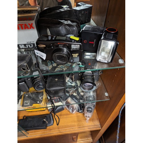 730 - Three shelves of cameras and accessories inc. Rollei 35 LED, Rollei A110, Konica, Pentax, Samsung et... 