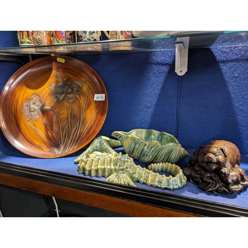 736 - Two studio pottery sealife decorations, daffodil relief tray and a resin sow with piglets