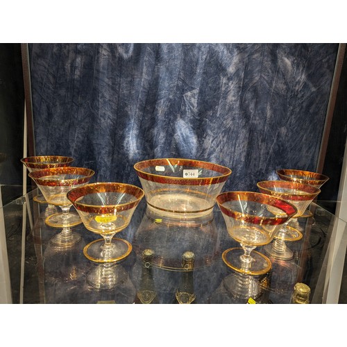 744 - Six cranberry and gilt decorated coupe glasses and bowl (dia.21cm approx.)