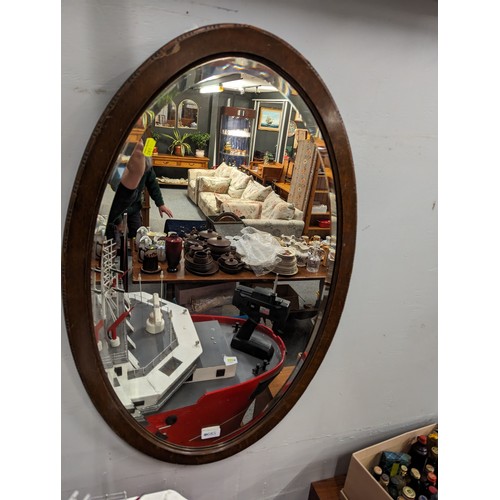 685 - Oval oak framed bevelled mirror