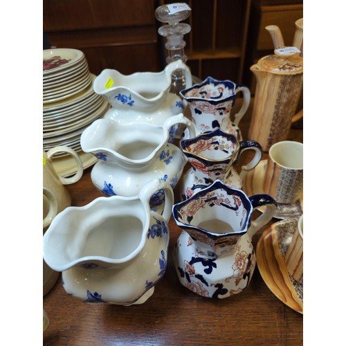 701 - Three Masons jugs, three Ironstone jugs and a glass decanter