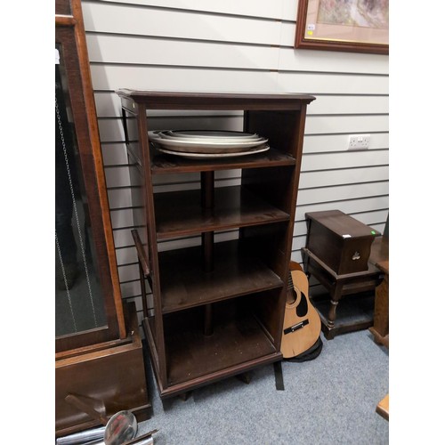 849 - Revolving mahogany bookcase with multiple shelves, incorporating two sheet music holding attachments... 