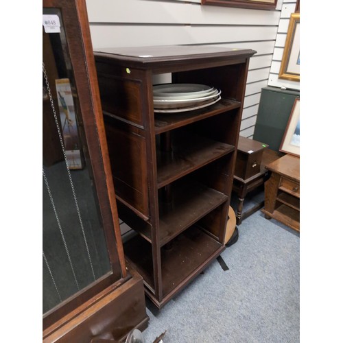 849 - Revolving mahogany bookcase with multiple shelves, incorporating two sheet music holding attachments... 