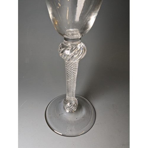 232 - Double-knopped air twist wine glass, circa 1750, the round funnel bowl above a multi-spiral stem and... 