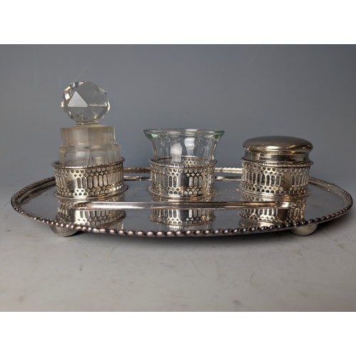 183 - Silver plated desk stand with three various glass pots