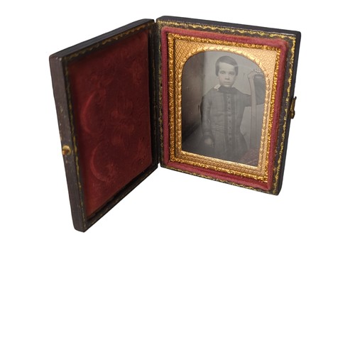 194 - Victorian leather cased daguerreotype portrait of a young boy, the case with ornate pressed decorati... 