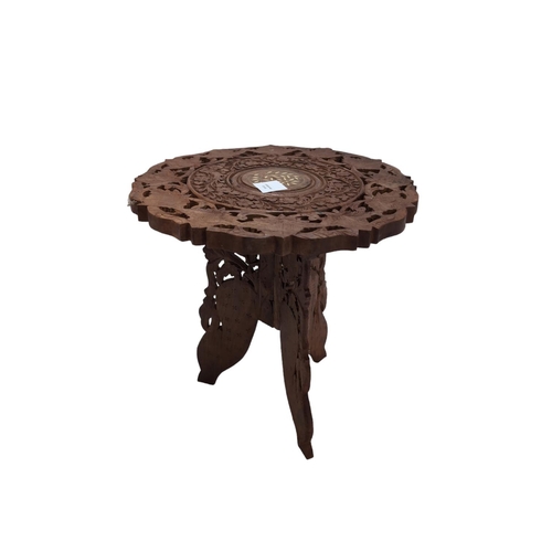 461 - Small teak folding carved occasional table. D38cm H38cm