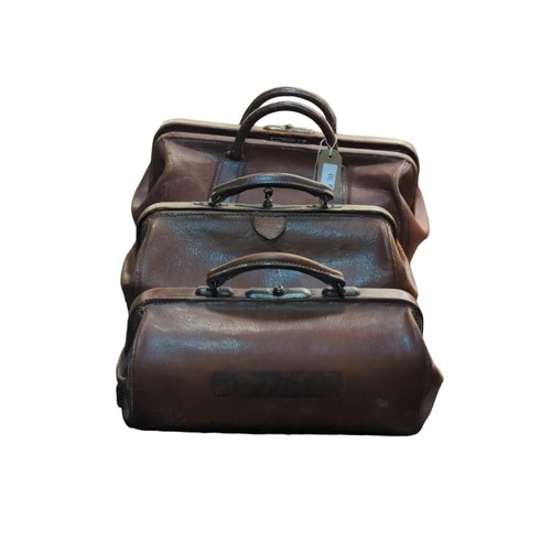 70 - 3 small leather Gladstone bags.