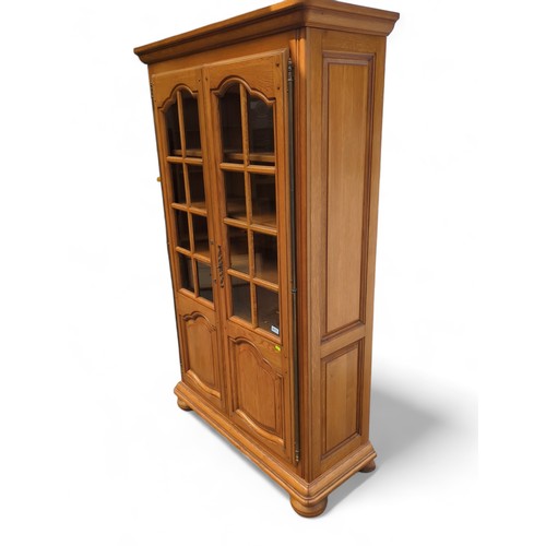 496 - Glass fronted bookcase W108 D42 H181cm