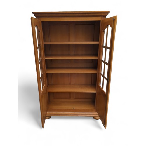 496 - Glass fronted bookcase W108 D42 H181cm