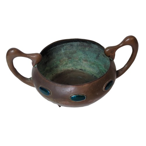 82 - Art Nouveau twin handled, three footed copper bowl set with six iridescent oval Ruskin type cabochon... 
