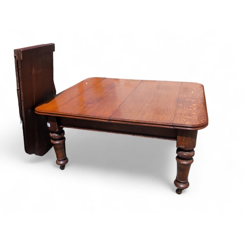 502 - Mahogany wind out extending dining table on casters with 2 extra leafs & winder handle 172 x 147... 