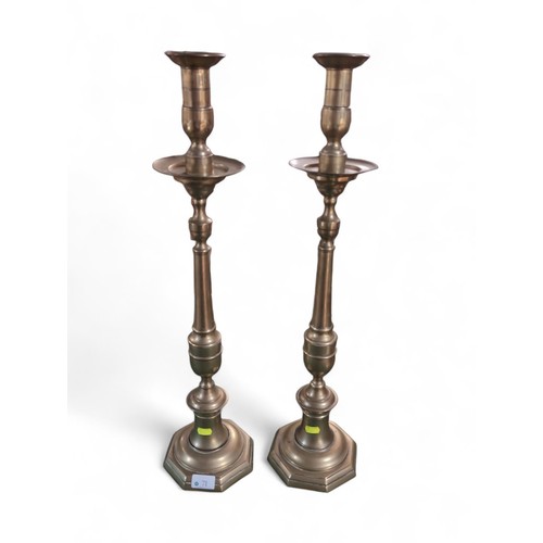 71 - Pair of tall brass candlesticks. H67cm.