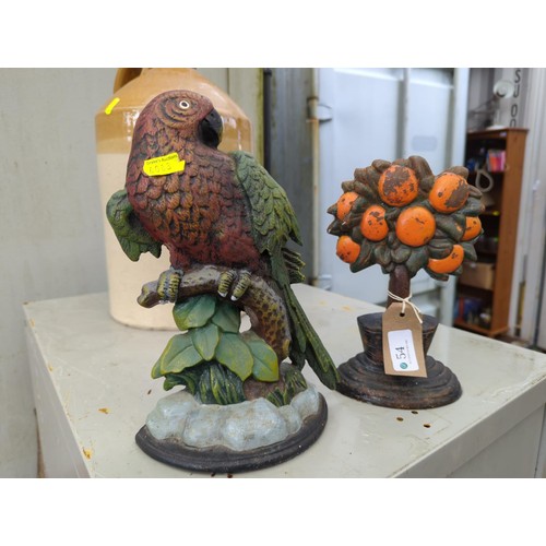 54 - 2 cast iron door stops. One of a parrot. One of a fruit tree. Tallest - 26cm.