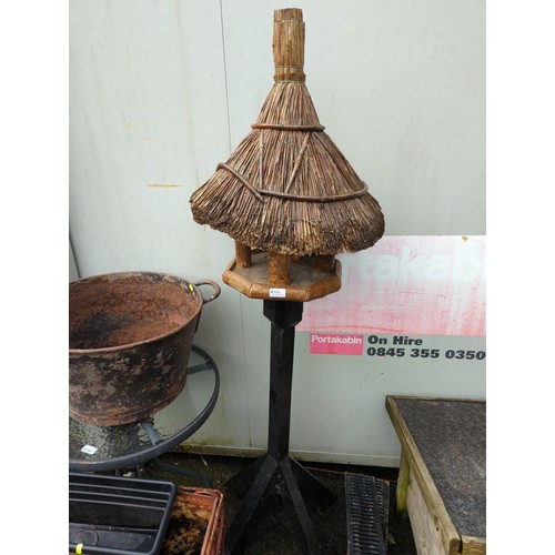 64 - Thatched roof, free-standing bird table. H174cm. 