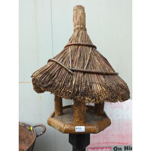 64 - Thatched roof, free-standing bird table. H174cm. 