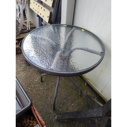 66 - Small, glass-topped, garden bistro table. Diameter - 60cm. H71cm. 