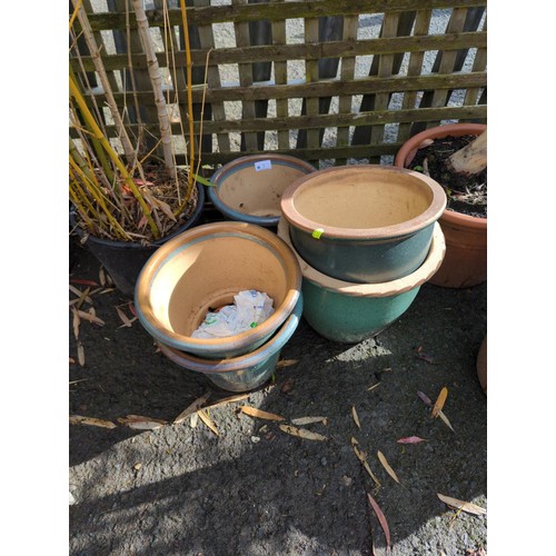 7 - 5 glazed terracotta pots. Largest diameter 30cm.