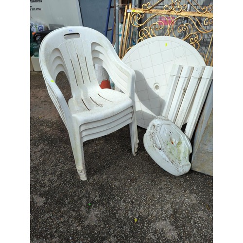 98 - White, plastic garden table + 4 chairs + parasol stand. Table diameter - 91cm.