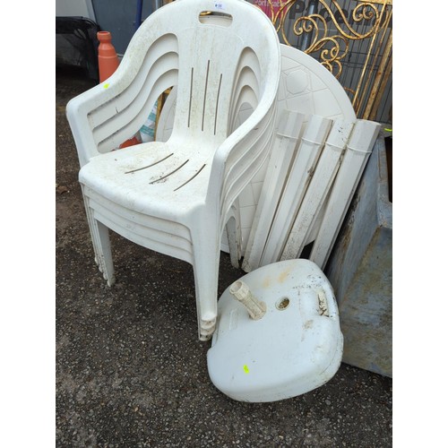 98 - White, plastic garden table + 4 chairs + parasol stand. Table diameter - 91cm.