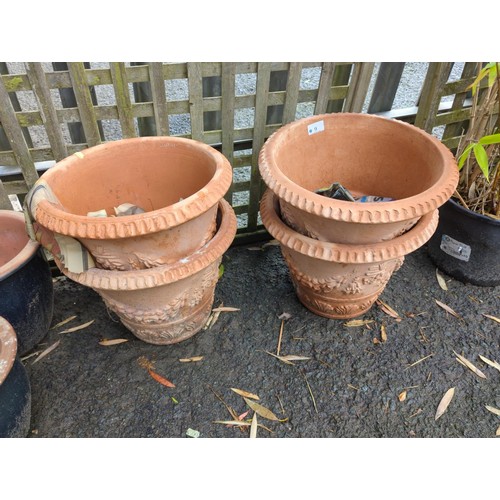 9 - 4 identical terracotta pots with design to sides. Diameter - 37cm.