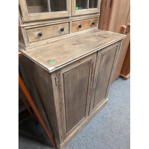 852 - Small, stripped pine, arch-topped, glazed dresser with 2 small drawers over cupboard. W82cm, D52cm, ... 